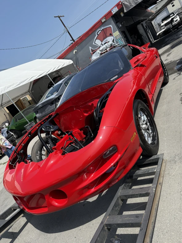 Professional collision repair work being performed on damaged vehicle