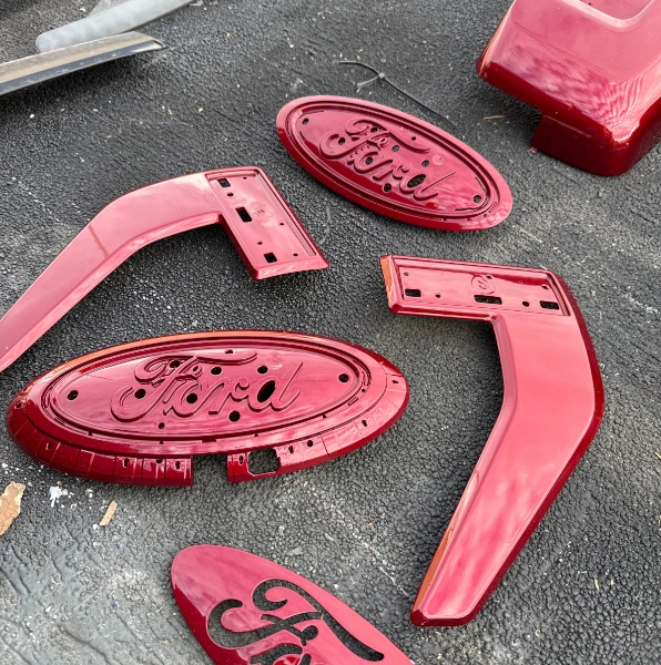 Custom red paint on all badges and side trim pieces for Ford truck
