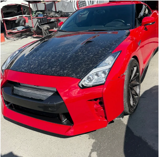 installation of carbon fiber hood and fresh bright red paint for Nissan GTR